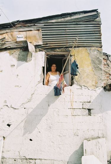 A Roma woman overlooking her house?s window in Sulukule district of Istanbul, Turkey. Stigmatization has been a major problem of Roma in Turkey, but the advocacy for their rights is just flourishing since a few years. Photo credit: Najla Osseiran