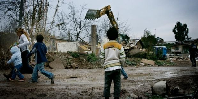 Romani boy watches the demolition of Romani homes in a forced eviction, Italy, 2009